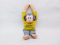 Plush monkey toy in yellow shirt and jeans with arms raised