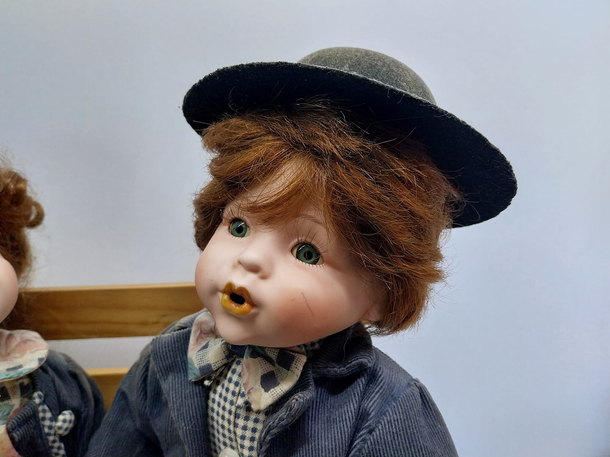 Vintage porcelain dolls - boy and girl on a wooden bench, from the 70s