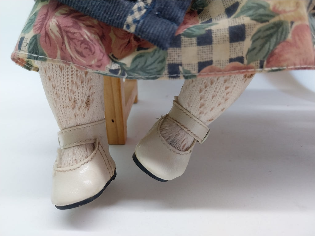Vintage porcelain dolls - boy and girl on a wooden bench, from the 70s