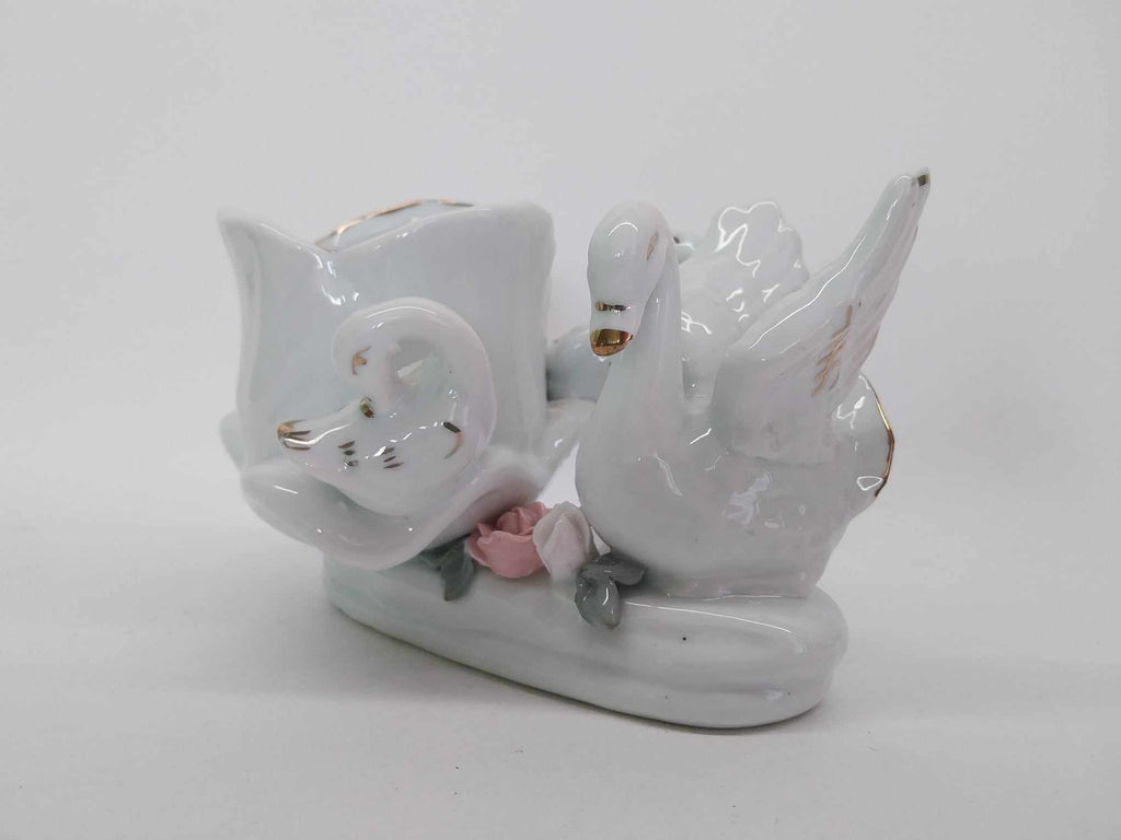 Vintage porcelain dove figurine with pink roses and gold accents - front view
