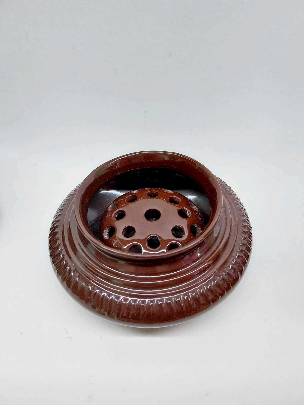 Vintage dark brown glazed ceramic flower frog with ribbed exterior and perforated insert