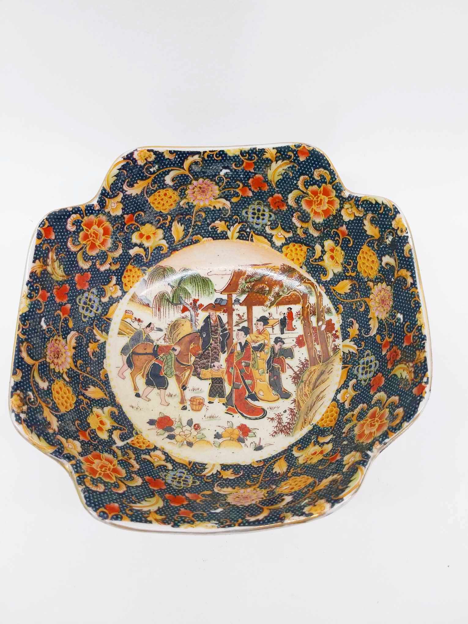 Interior of vintage Japanese porcelain bowl showing hand-painted courtly scene with figures and pavilion