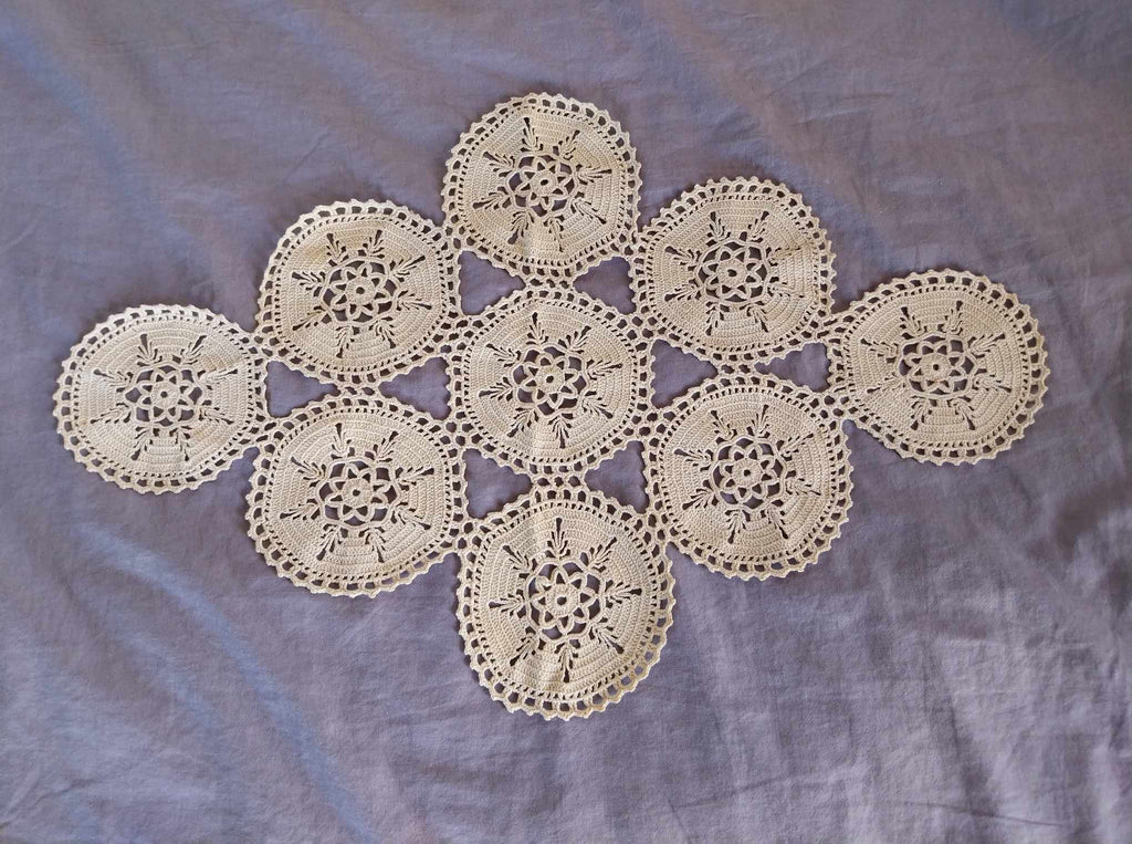 Vintage Bulgarian hand-crocheted cotton doily with nine floral medallions in natural cream