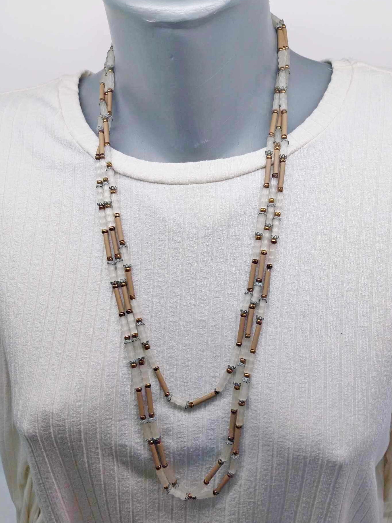 Vintage multi-strand beaded necklace on mannequin showing layered drape
