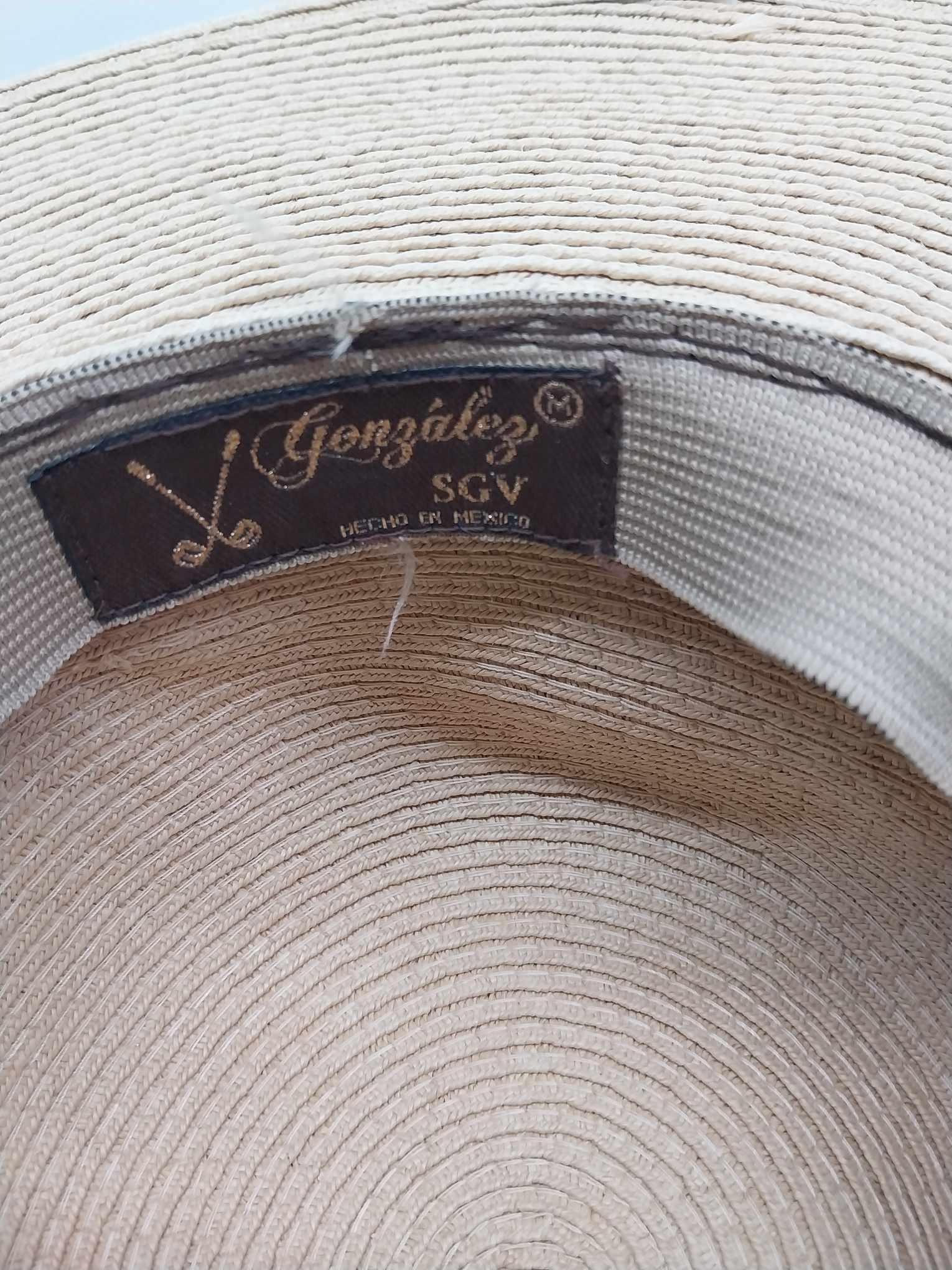 González SGV vintage straw hat side view showing wide brim and wooden bead trim