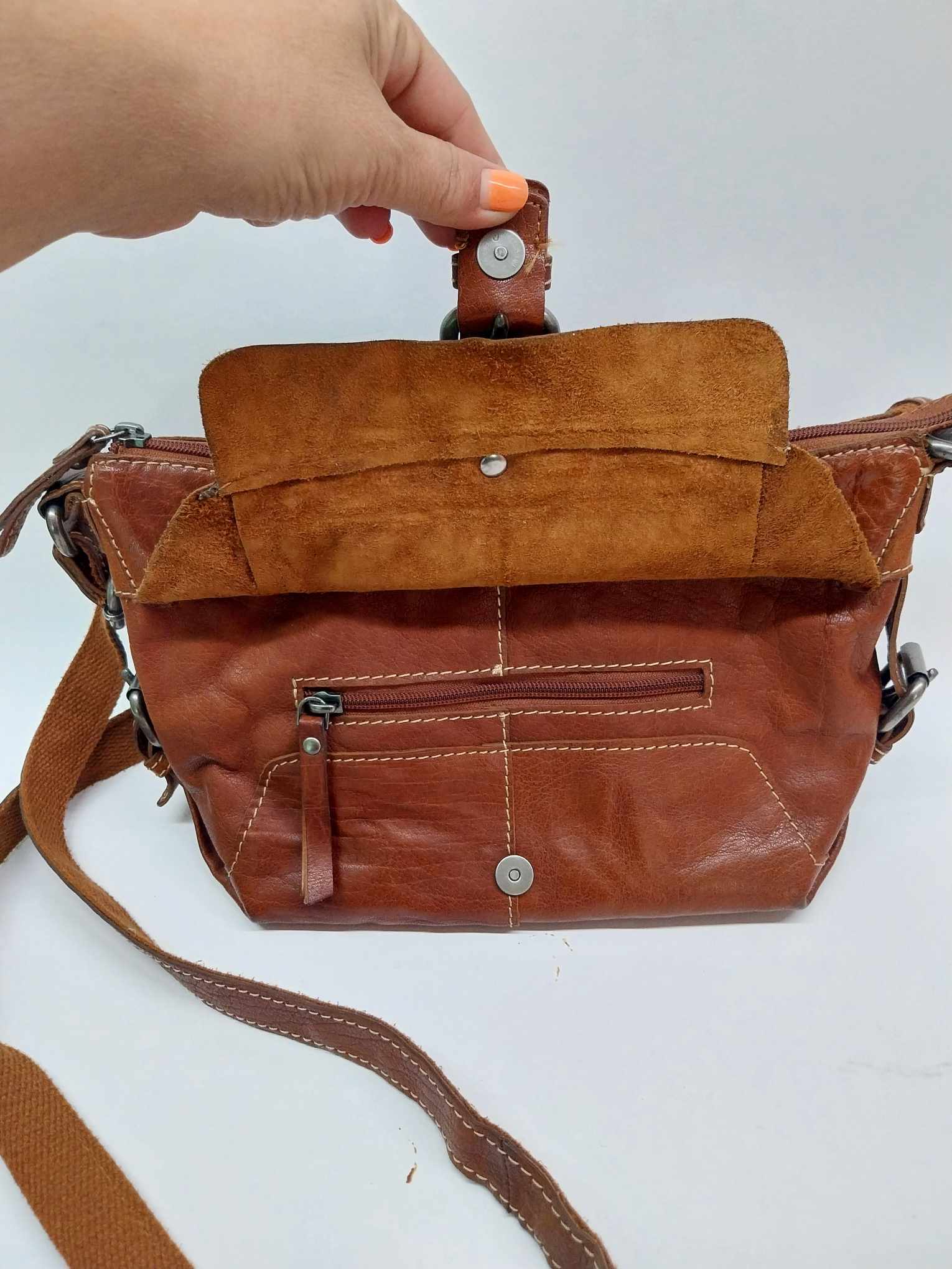 Varese vintage leather crossbody bag — front flap pocket open detail