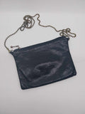 Vintage Etui London black leather clutch bag with antique bronze ball chain strap, flat lay on white background