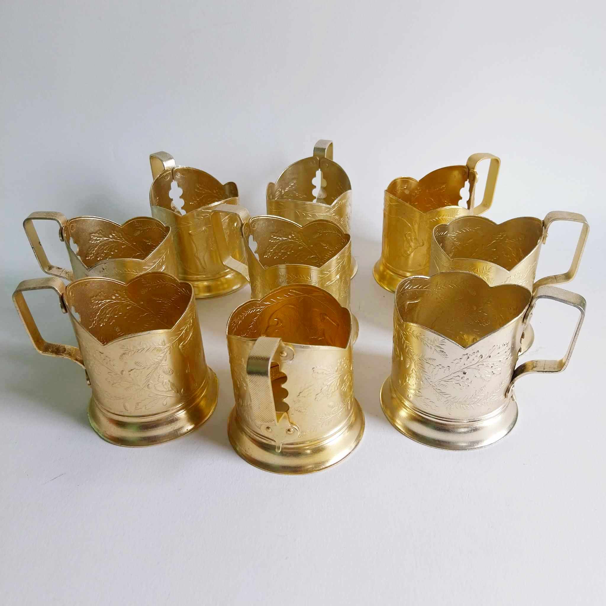 Set of 9 vintage Soviet aluminium podstakannik tea glass holders with engraved floral decoration