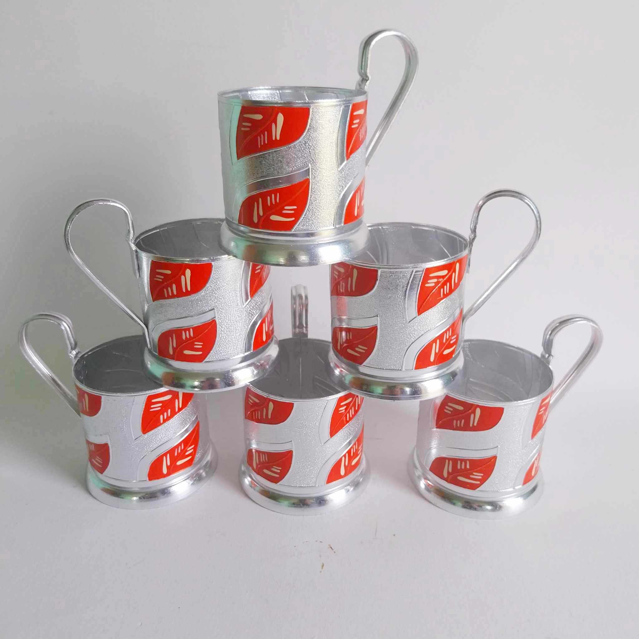 Set of 6 vintage Soviet podstakannik chrome tea glass holders with red and silver enamel decoration, stacked in pyramid