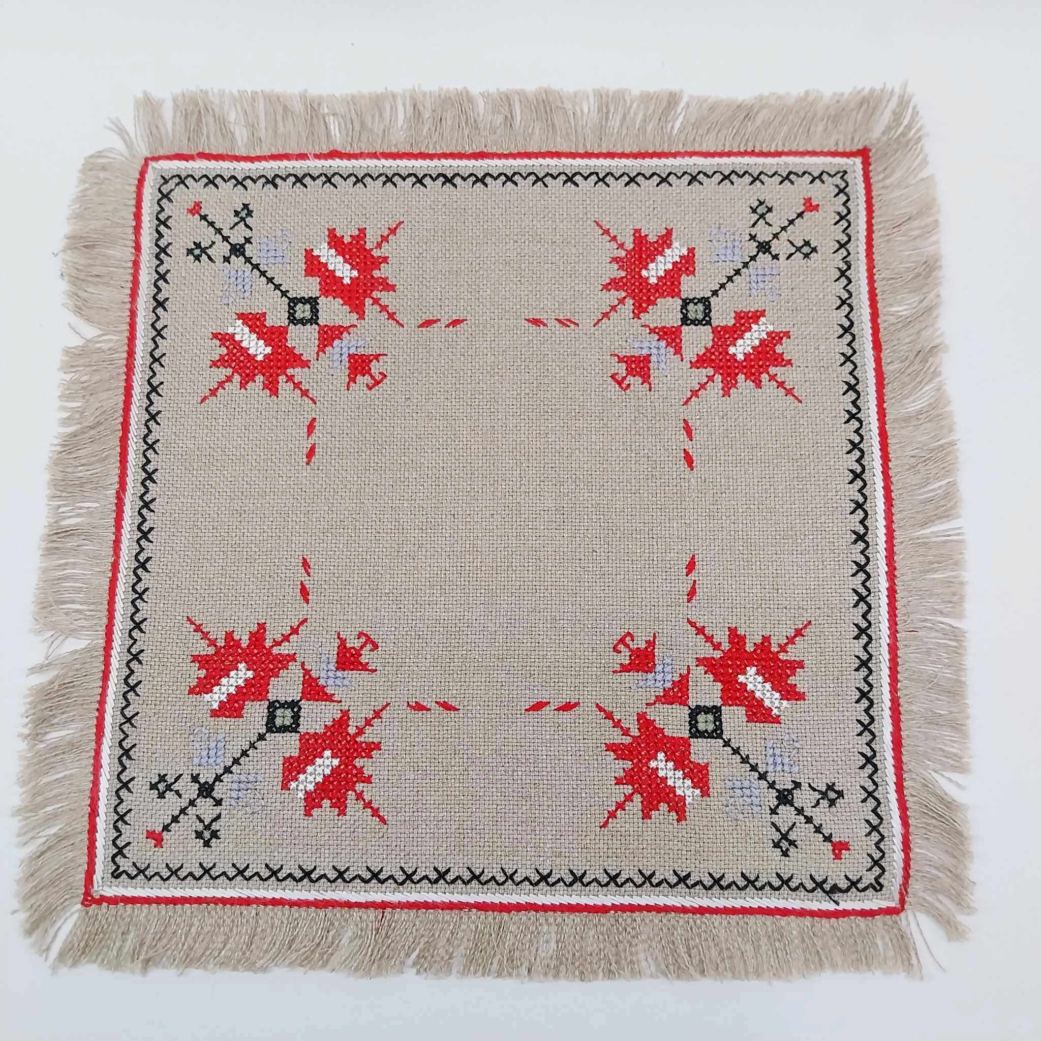 Vintage hand-embroidered linen doily with red folk cross-stitch motifs and fringed border, 33cm