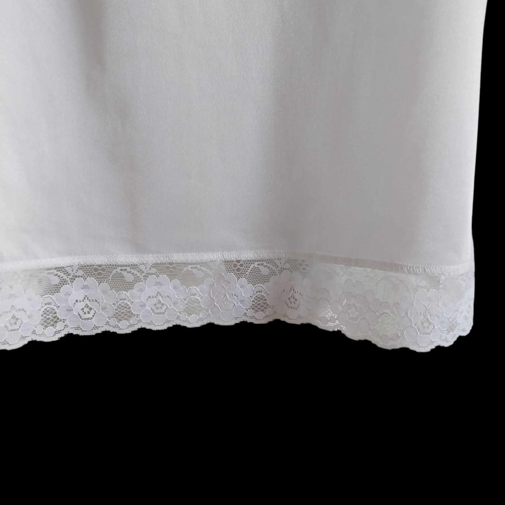 Close-up of lace hem detail on vintage white full slip