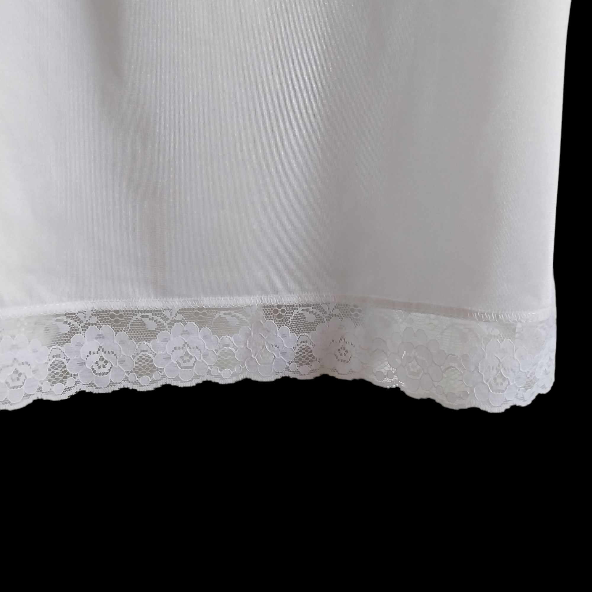 Close-up of lace hem detail on vintage white full slip
