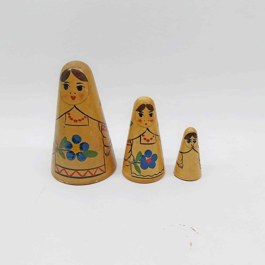 Set of three vintage hand-painted Russian matryoshka nesting dolls in graduated sizes