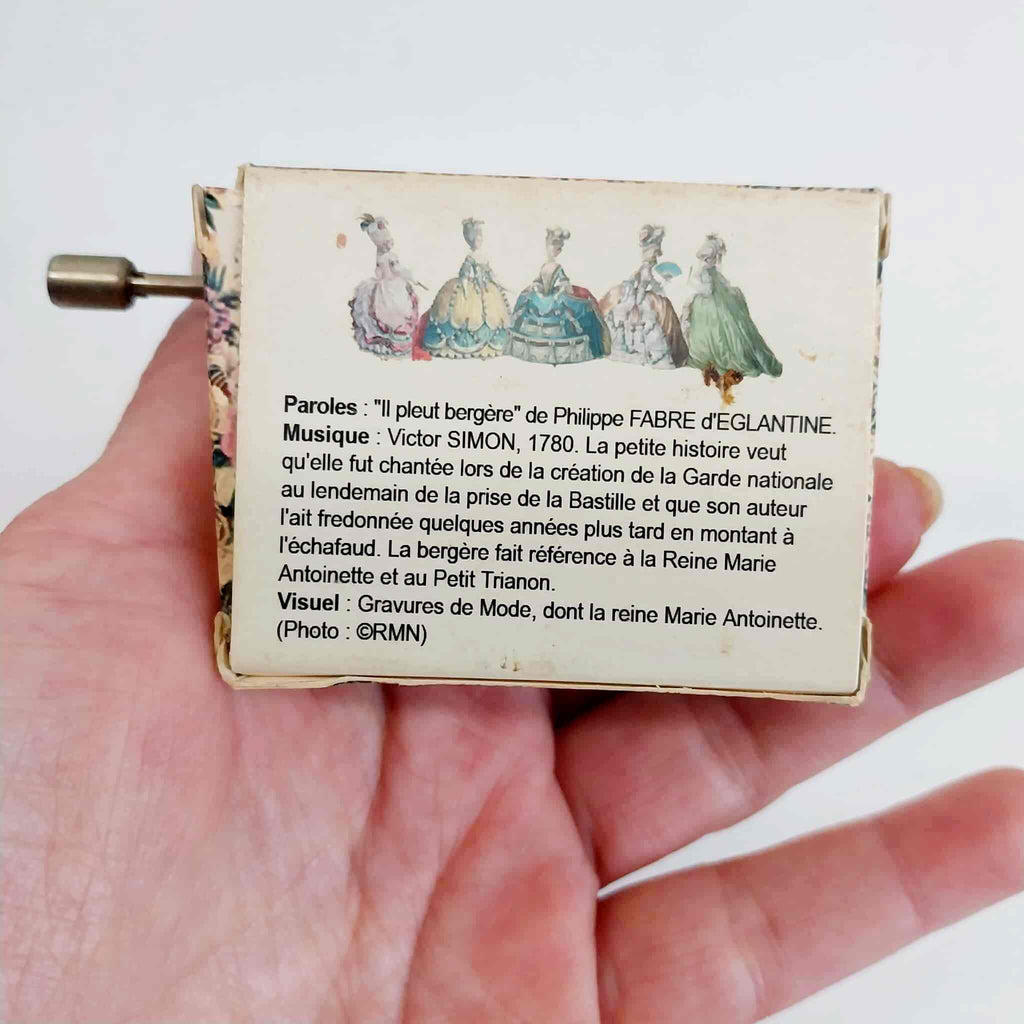 Back of music box with French text and historical description