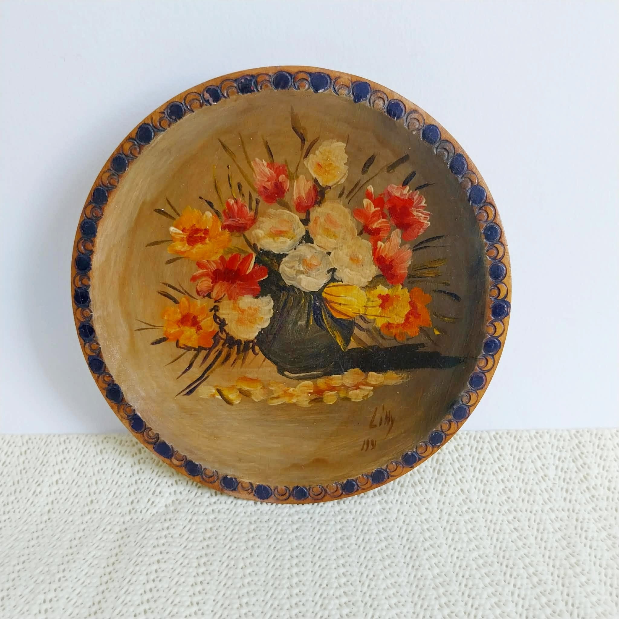 Vintage hand-painted wooden decorative plate – artist signature close-up