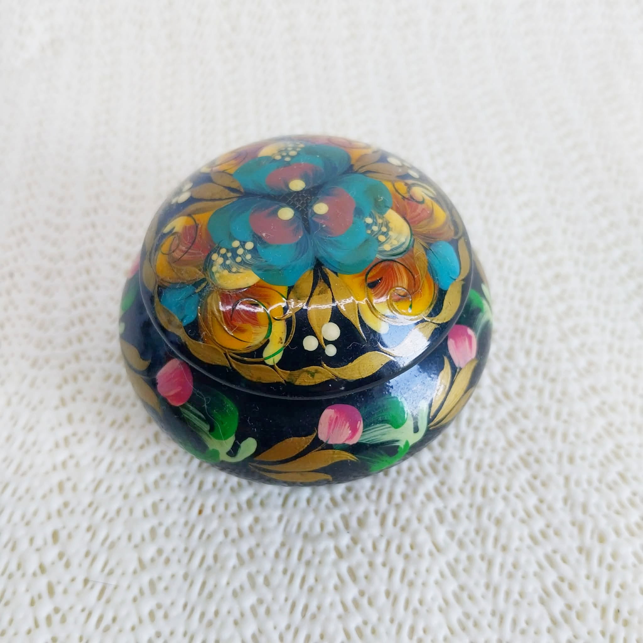 Vintage Ukrainian lacquered wooden trinket box closed — Petrykivka floral motifs on black