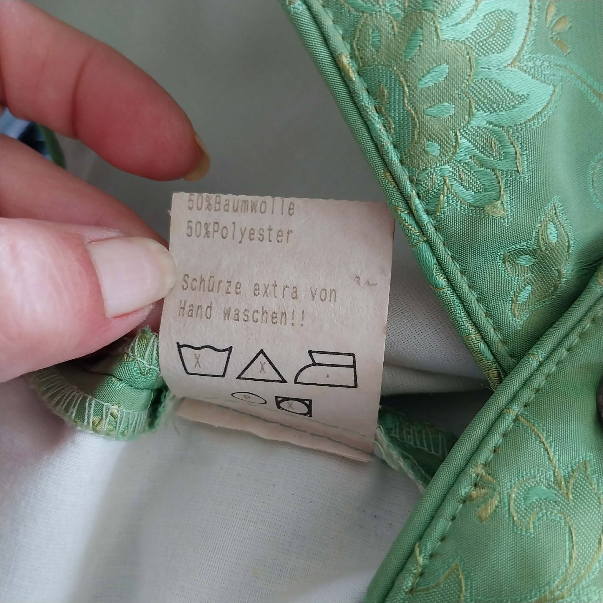 Care label showing hand wash instructions for apron