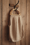 Handmade beige cotton knit bag with plastic D-shaped handles, vintage style