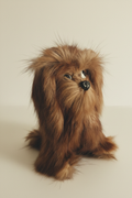Vintage natural fur dog figurine resembling a fluffy Pekingese puppy with glass eyes, clear bright product photo