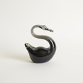 Vintage black art glass swan figurine on light background