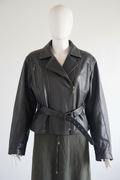 Vintage black leather biker jacket centered front view on mannequin
