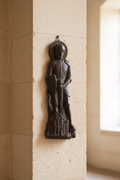 Vintage paraffin saint knight wall figurine on light background