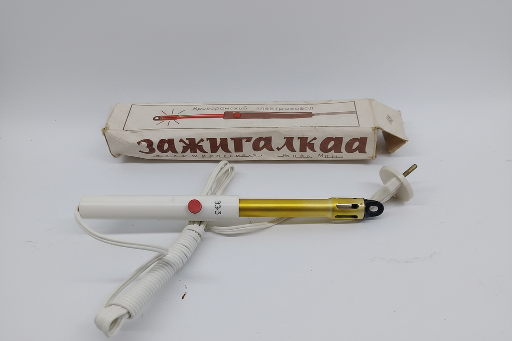 Soviet vintage electric lighter Zazhigalka ZZZ with original cardboard box on light concrete surface