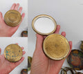 Vintage gold powder compact with honeycomb pattern and turquoise enamel, shown open with mirror